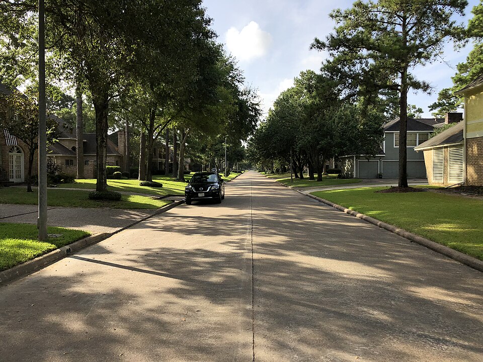 A tree-lined residential street in the Pin Oak subdivision near Katy